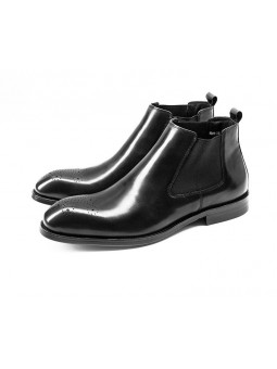 Black Chelsea boots in cowhide leather with brogue details, side elastics, and back pull tab.