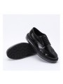 Scarpe brogue in vera pelle nera con suola trasparente, un perfetto equilibrio tra eleganza classica e modernità.