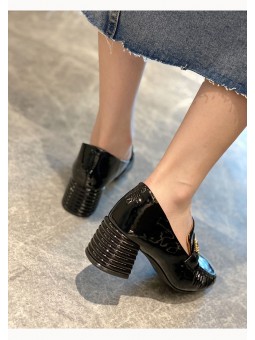 Black patent leather loafers with a mid heel and metal bit detail. Leather insole and rubber outsole for maximum comfort