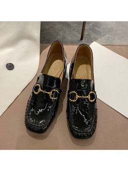 Black patent leather loafers with a mid heel and metal bit detail. Leather insole and rubber outsole for maximum comfort