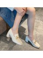 White patent leather loafers with a mid heel and metal bit detail. Leather insole and rubber outsole for maximum comfort.
