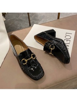 Black patent leather loafers with a mid heel and metal bit detail. Leather insole and rubber outsole for maximum comfort