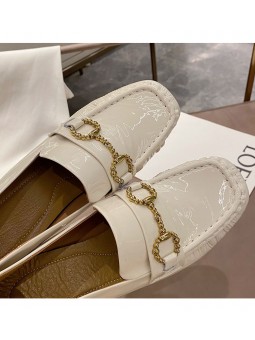 White patent leather loafers with a mid heel and metal bit detail. Leather insole and rubber outsole for maximum comfort.