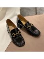 Black patent leather loafers with a mid heel and metal bit detail. Leather insole and rubber outsole for maximum comfort