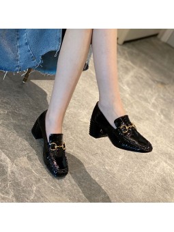 Black patent leather loafers with a mid heel and metal bit detail. Leather insole and rubber outsole for maximum comfort