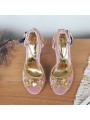 Pink velvet sandals with a high block heel, strap closure with buckle, and gold leather insole for a chic finish.