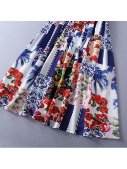 Long multicolored summer dress with straps, featuring a patchwork print of arabesques and stripes