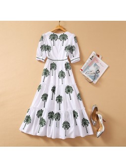 White flowing dress with palm tree pattern