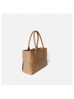 arge braided smooth leather tote bag in apricot. Gold finish and adjustable strap. Subtle freshness.