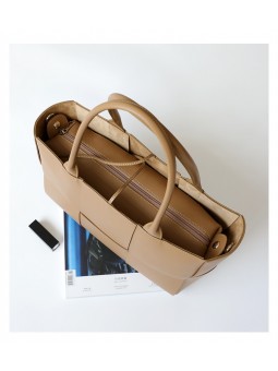 arge braided smooth leather tote bag in apricot. Gold finish and adjustable strap. Subtle freshness.
