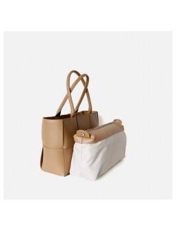 arge braided smooth leather tote bag in apricot. Gold finish and adjustable strap. Subtle freshness.