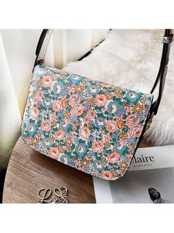 Printed bit leather bag, wearable on the shoulder or as a crossbody with its adjustable leather strap adorned with gold rivets.