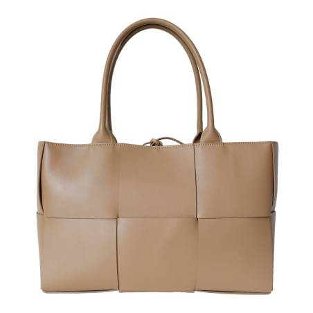arge braided smooth leather tote bag in apricot. Gold finish and adjustable strap. Subtle freshness.