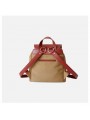 Beige two-tone women’s bag with leather handle, drawstring and belted flap closure.