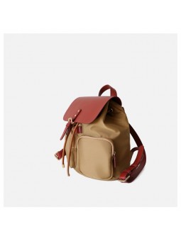 Beige two-tone women’s bag with leather handle, drawstring and belted flap closure.