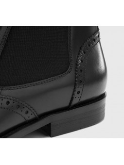 Black leather Chelsea boots with brogue details, side elastics, straight toe and heel.