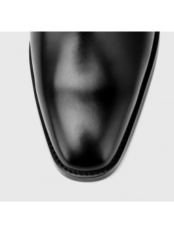 Black leather lace-up ankle boots with straight toe, low heel and three eyelets.