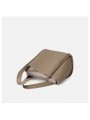 Sac seau en cuir grainé beige, fermeture à bouton pression métallique et finition argentée.