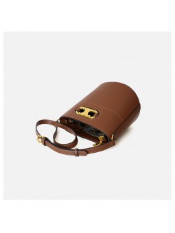 Brown leather bucket bag, with an adjustable and removable leather strap for crossbody wear. Refined gold-tone details.