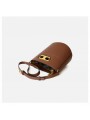 Brown leather bucket bag, with an adjustable and removable leather strap for crossbody wear. Refined gold-tone details.