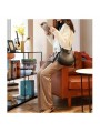Brown leather bucket bag with strap closure and leather handle, visible stitching.