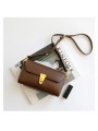 Retro baguette shoulder bag in brown leather with flap and vintage metal clasp.