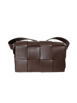 Brown cassette bag with woven leather shoulder strap, magnetic button closure, gold finish.